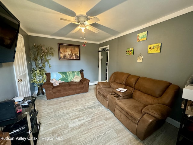 living room featuring a baseboard radiator, ornamental molding, a ceiling fan, and wood finished floors