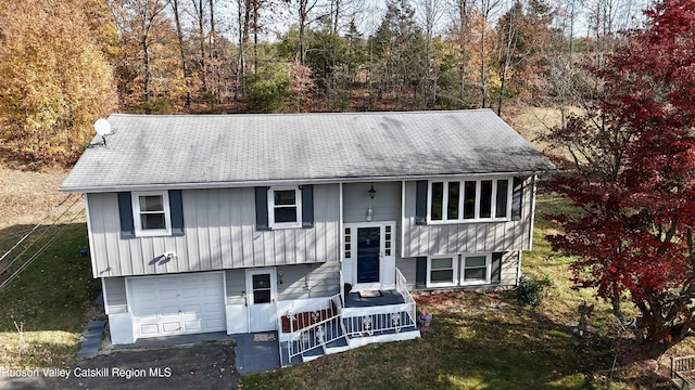 bi-level home with a front lawn and an attached garage