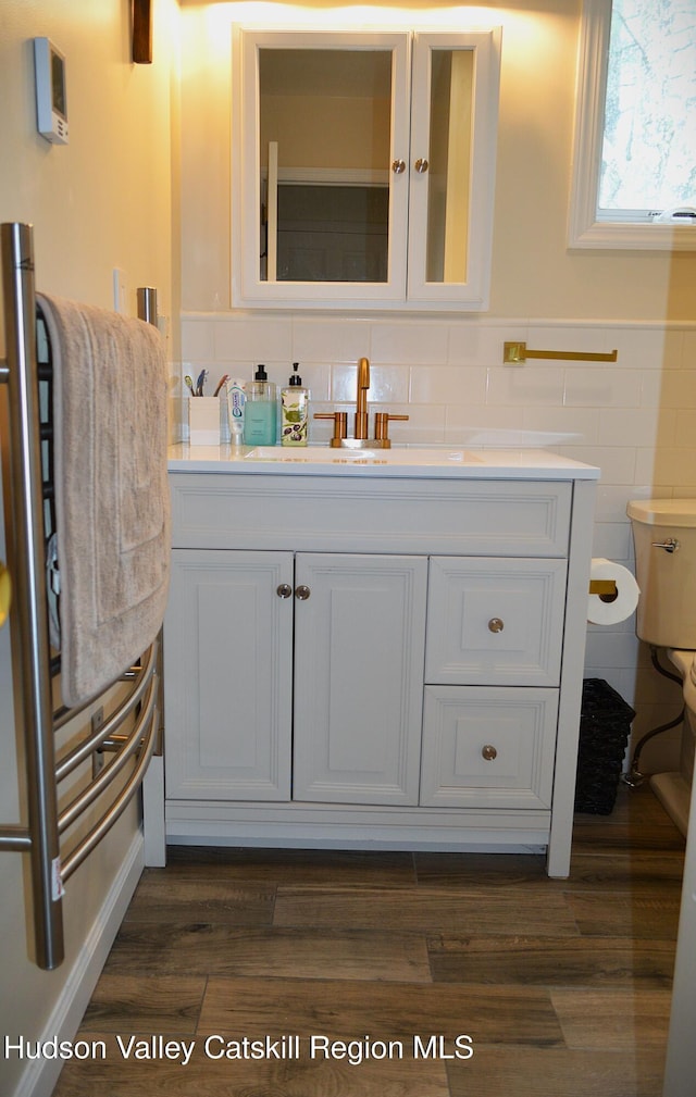 100 Clear Spring Ln, Fleischmanns, NY 12406 - bathroom with tile walls, vanity, toilet, wood finished floors, and wainscoting