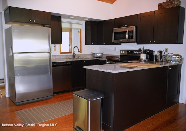 100 Clear Spring Ln, Fleischmanns, NY 12406 - kitchen with stainless steel appliances, wood finished floors, a peninsula, and a sink