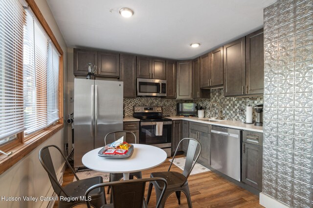 11 Quads Way, Windham, NY 12496 - kitchen featuring stainless steel appliances, a sink, light countertops, backsplash, and dark brown cabinetry