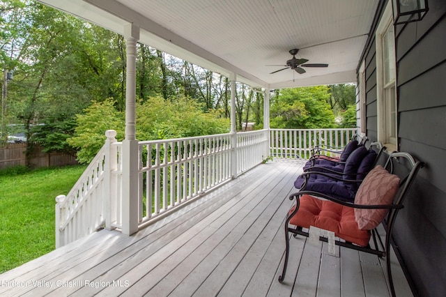 deck with a yard, covered porch, and ceiling fan