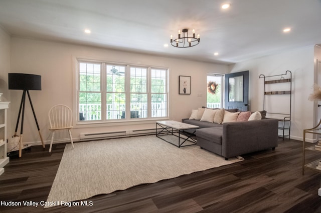 living room with dark hardwood / wood-style floors, a chandelier, and baseboard heating