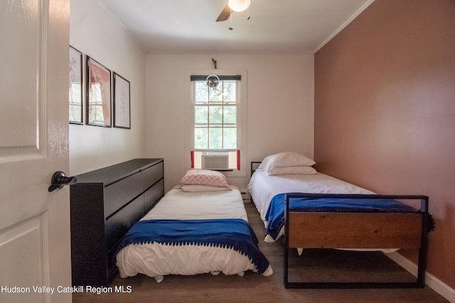 bedroom with crown molding, cooling unit, and ceiling fan