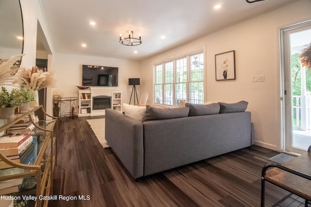 living room featuring a notable chandelier and dark hardwood / wood-style floors