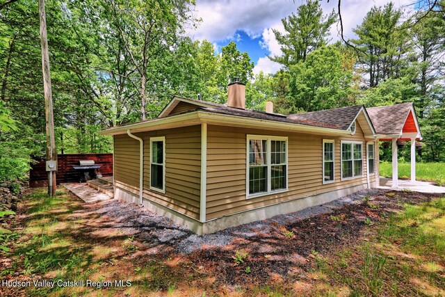 534 Rte 145, Cairo, NY 12413 - view of side of home with a chimney, a patio area, and view of wooded area