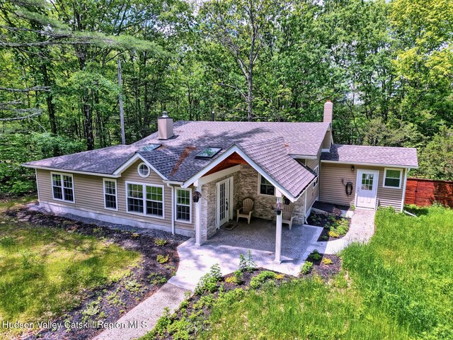 534 Rte 145, Cairo, NY 12413 - view of front of home featuring a chimney, stone siding, a shingled roof, and a patio area