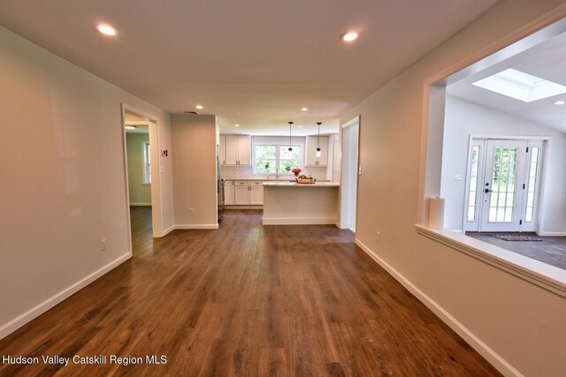 534 Rte 145, Cairo, NY 12413 - unfurnished living room featuring a skylight, dark wood finished floors, baseboards, and recessed lighting