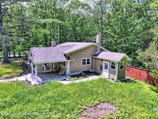 534 Rte 145, Cairo, NY 12413 - back of property featuring a chimney, roof with shingles, stone siding, and a patio area