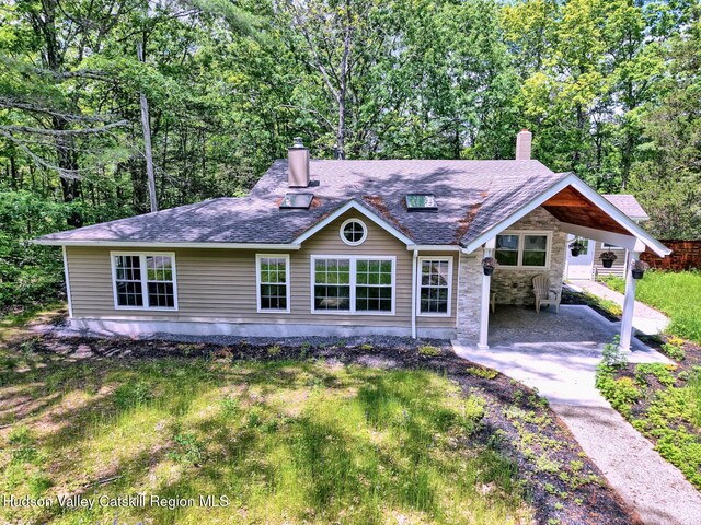 534 Rte 145, Cairo, NY 12413 - view of front of house with a chimney, stone siding, driveway, and an attached carport