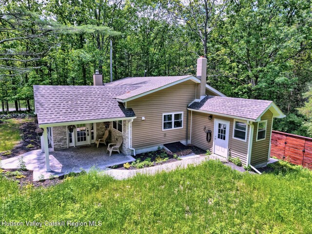 534 Rte 145, Cairo, NY 12413 - back of property with a chimney, a patio, roof with shingles, and stone siding