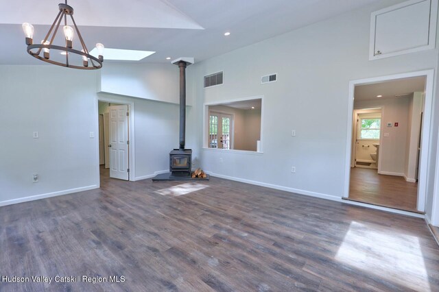 534 Rte 145, Cairo, NY 12413 - unfurnished living room featuring a wood stove, high vaulted ceiling, dark wood-type flooring, recessed lighting, and baseboards
