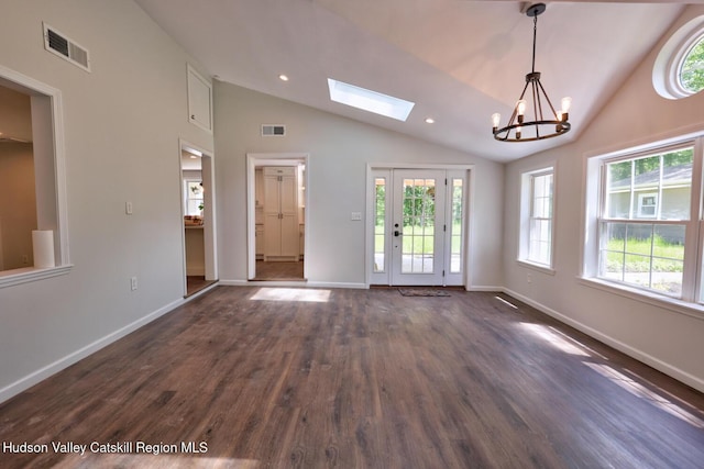 534 Rte 145, Cairo, NY 12413 - unfurnished living room featuring vaulted ceiling, dark wood-style floors, a chandelier, a skylight, and baseboards