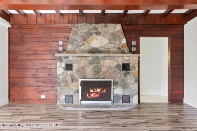 603-607 Old Stage Rd, Saugerties, NY 12477 - room details featuring visible vents, beam ceiling, wood finished floors, a stone fireplace, and wooden walls