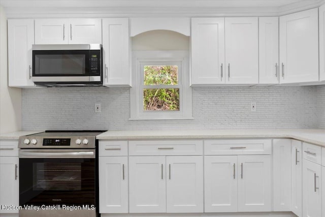 603-607 Old Stage Rd, Saugerties, NY 12477 - kitchen with decorative backsplash, white cabinetry, and appliances with stainless steel finishes