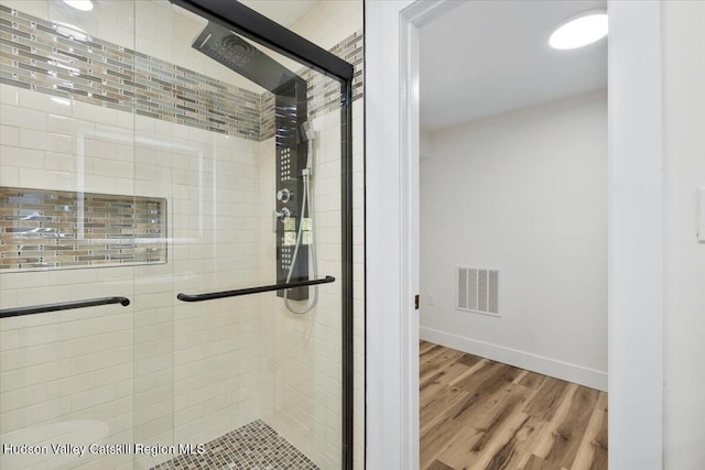 603-607 Old Stage Rd, Saugerties, NY 12477 - full bathroom with baseboards, visible vents, a shower stall, and wood finished floors