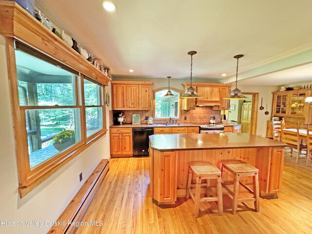 kitchen featuring pendant lighting, stainless steel electric range, sink, black dishwasher, and tasteful backsplash