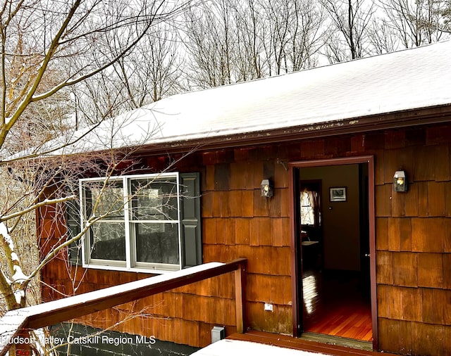 view of snow covered property entrance