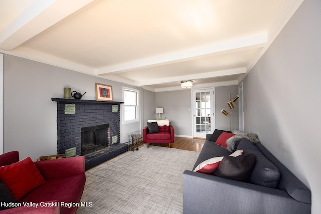 592 County Route 6, High Falls, NY 12440 - living room with baseboards, wood finished floors, beamed ceiling, and a brick fireplace