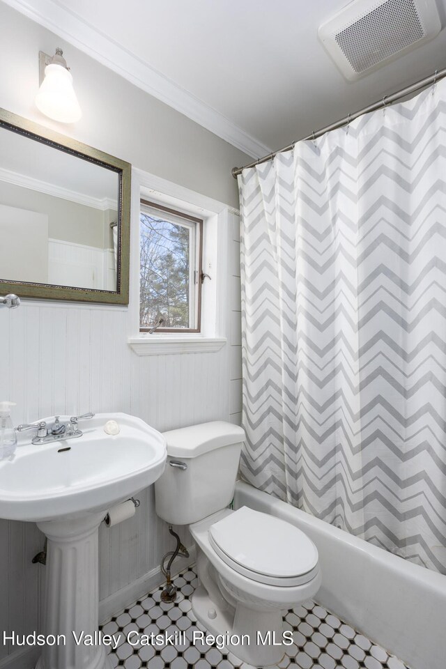 592 County Route 6, High Falls, NY 12440 - bathroom featuring crown molding, toilet, a sink, shower / bath combo with shower curtain, and visible vents