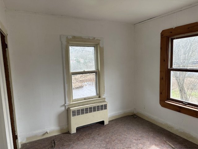 unfurnished room featuring radiator heating unit