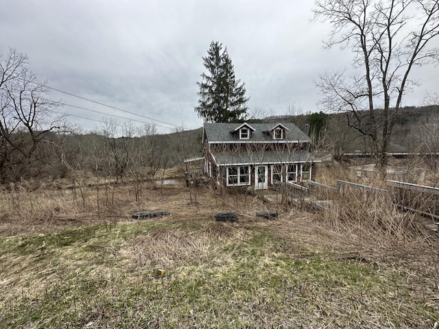 rear view of house with covered porch