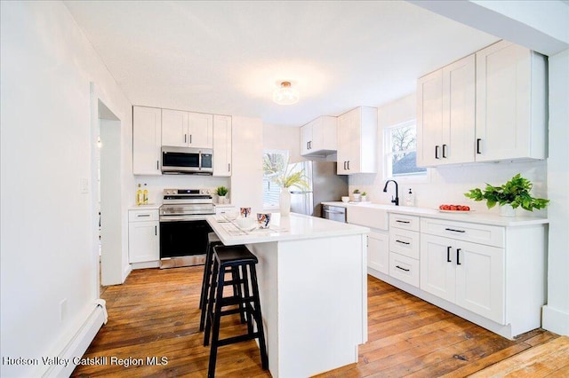 1792 State Route 213, Ulster Park, NY 12487 - kitchen featuring stainless steel appliances, light countertops, and white cabinetry