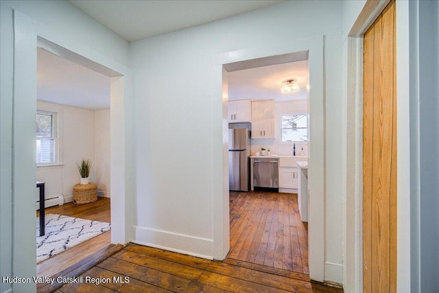 1792 State Route 213, Ulster Park, NY 12487 - hallway with wood-type flooring, a baseboard radiator, and healthy amount of natural light