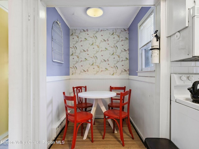 2481 Rte 145, East Durham, NY 12423 - dining room with crown molding, wood finished floors, a baseboard radiator, and a wainscoted wall