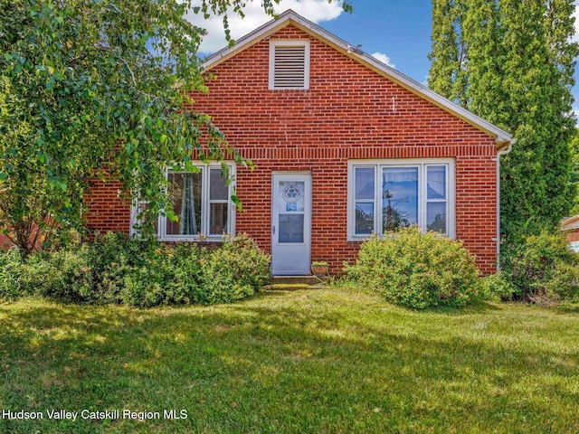 2481 Rte 145, East Durham, NY 12423 - view of front of house featuring a front yard and brick siding