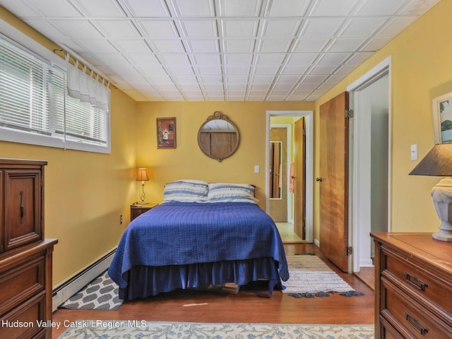 2481 Rte 145, East Durham, NY 12423 - bedroom with a baseboard heating unit and wood finished floors