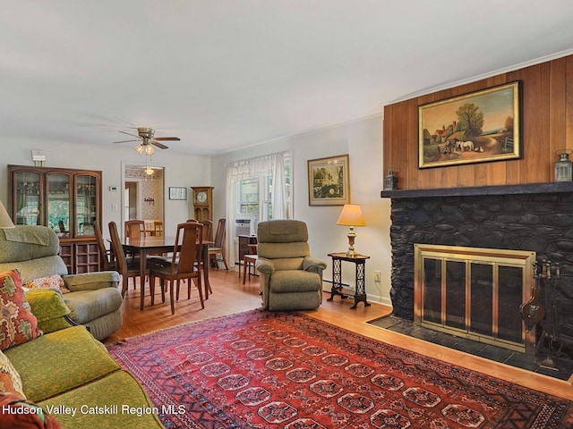 2481 Rte 145, East Durham, NY 12423 - living room with wood finished floors, ceiling fan, a stone fireplace, and baseboard heating