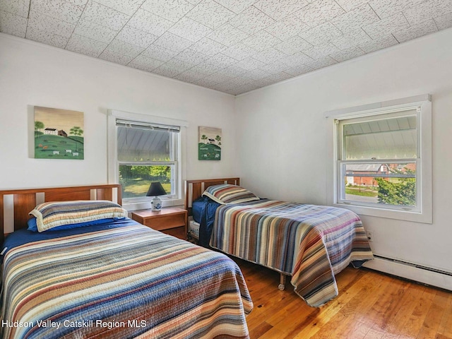2481 Rte 145, East Durham, NY 12423 - bedroom with baseboard heating and hardwood / wood-style flooring