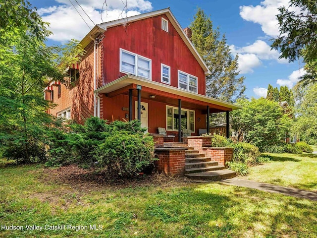 2481 Rte 145, East Durham, NY 12423 - view of front of property with a porch, a front yard, and a chimney