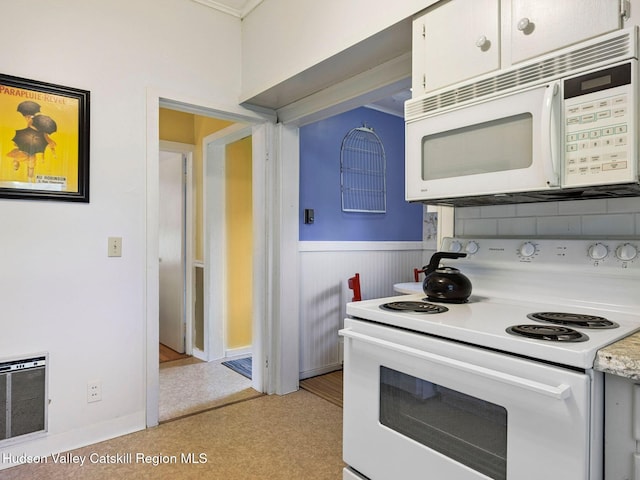 2481 Rte 145, East Durham, NY 12423 - kitchen featuring white appliances, a wainscoted wall, light countertops, white cabinetry, and heating unit