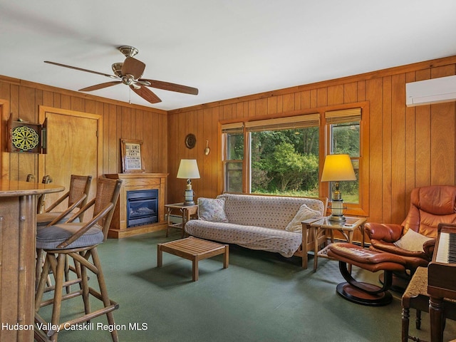2481 Rte 145, East Durham, NY 12423 - living room featuring wooden walls, a glass covered fireplace, a wall mounted AC, and ceiling fan