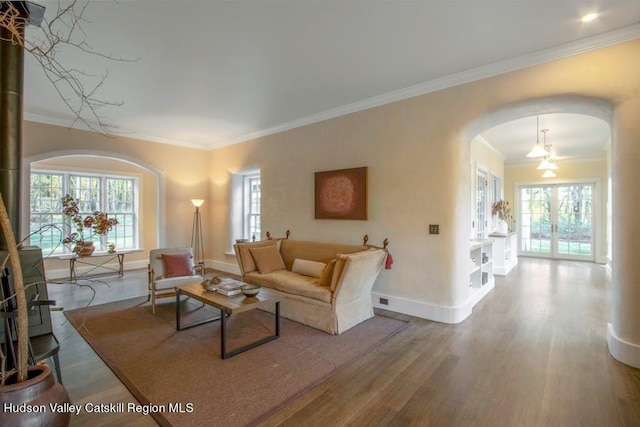 living room featuring plenty of natural light, hardwood / wood-style floors, and ornamental molding