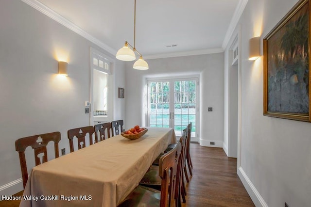 dining area featuring french doors, dark hardwood / wood-style flooring, and ornamental molding