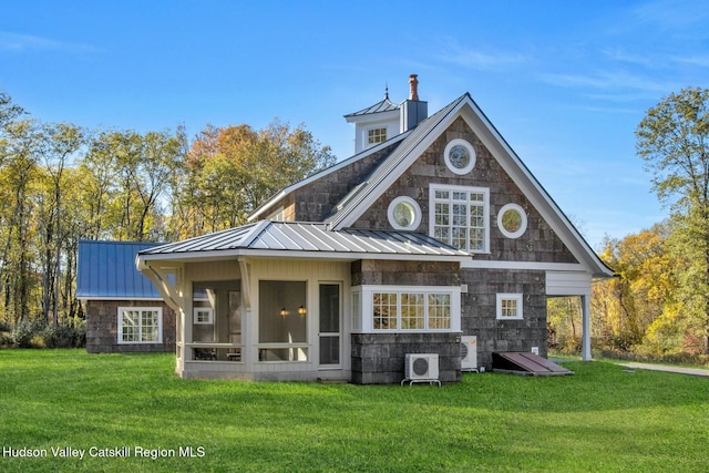 rear view of property with a yard, a sunroom, and ac unit