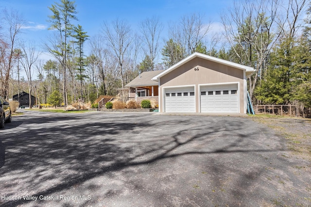 220 John Joy Rd, Woodstock, NY 12498 - view of side of property featuring asphalt driveway, covered porch, and an attached garage