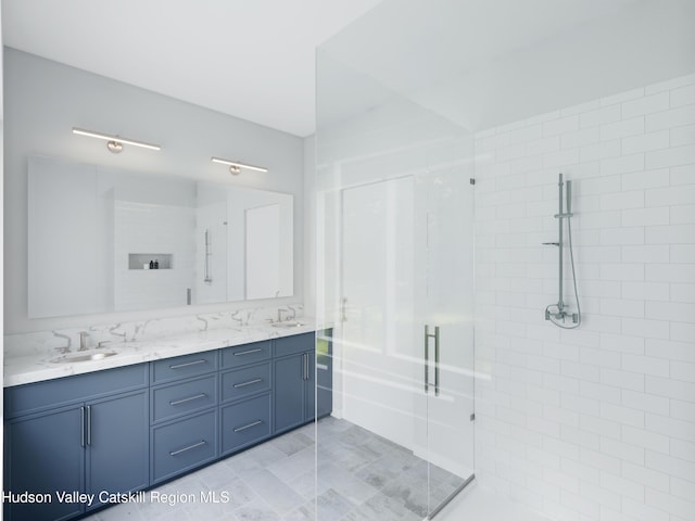 bathroom featuring vanity and a shower with door