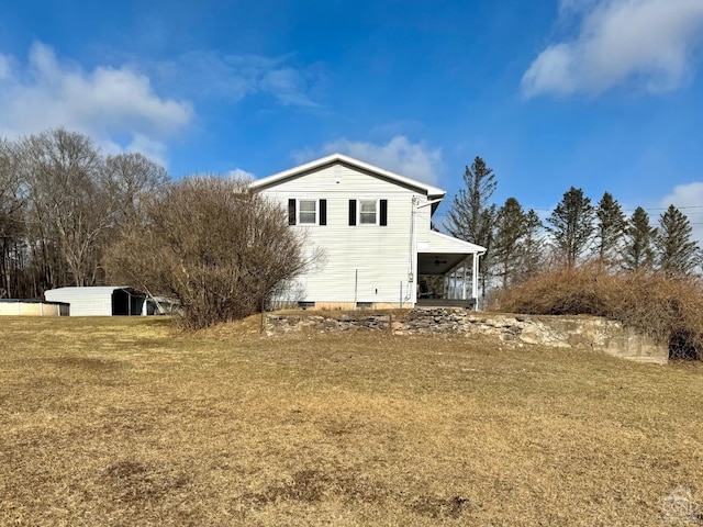 view of side of home with a yard