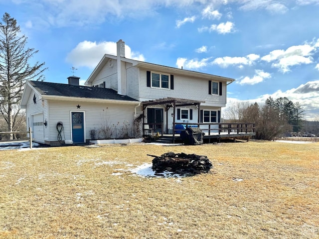 back of house with a chimney, a pergola, a wooden deck, and a garage