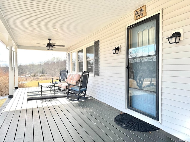 wooden deck with a porch and ceiling fan