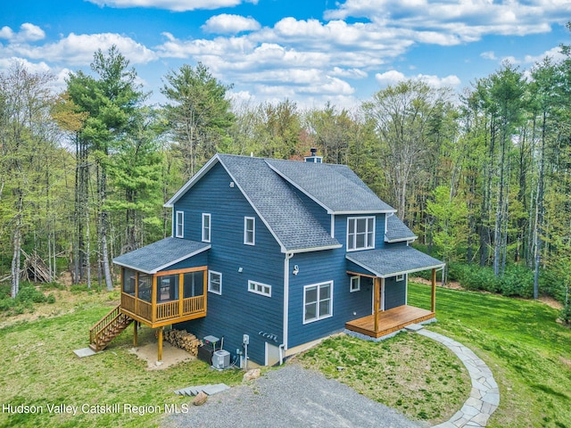 51 Houtman Rd, Saugerties, NY 12477 - back of property featuring roof with shingles, a wooden deck, a sunroom, a lawn, and a wooded view