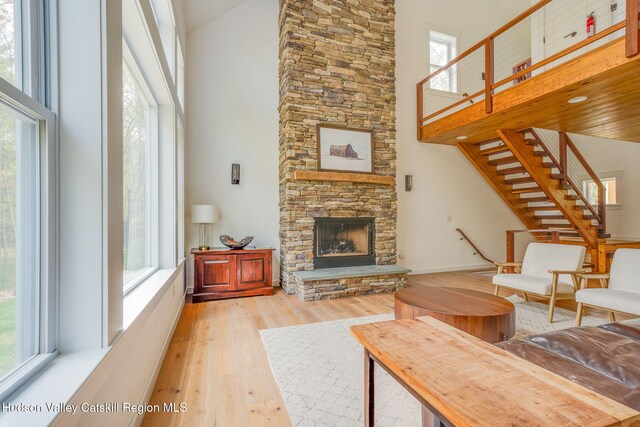 51 Houtman Rd, Saugerties, NY 12477 - living room with light wood-style flooring, a high ceiling, a wealth of natural light, and a fireplace