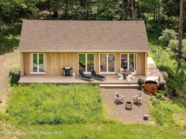 129 Krum Rd, Kerhonkson, NY 12446 - rear view of house featuring a wooden deck, an outdoor fire pit, and roof with shingles