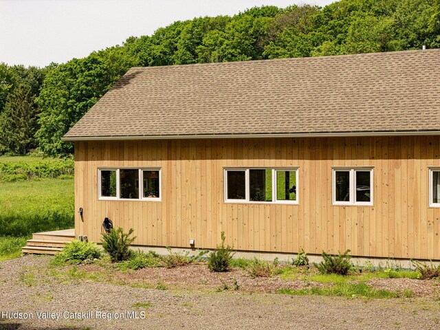 129 Krum Rd, Kerhonkson, NY 12446 - view of side of home with a forest view and a shingled roof