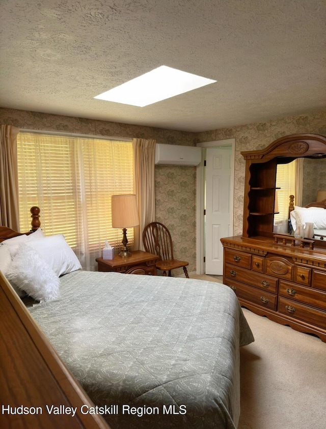 51 Patroon St, Claverack-Red Mills, NY 12513 - bedroom featuring an AC wall unit, a textured ceiling, a skylight, carpet flooring, and wallpapered walls