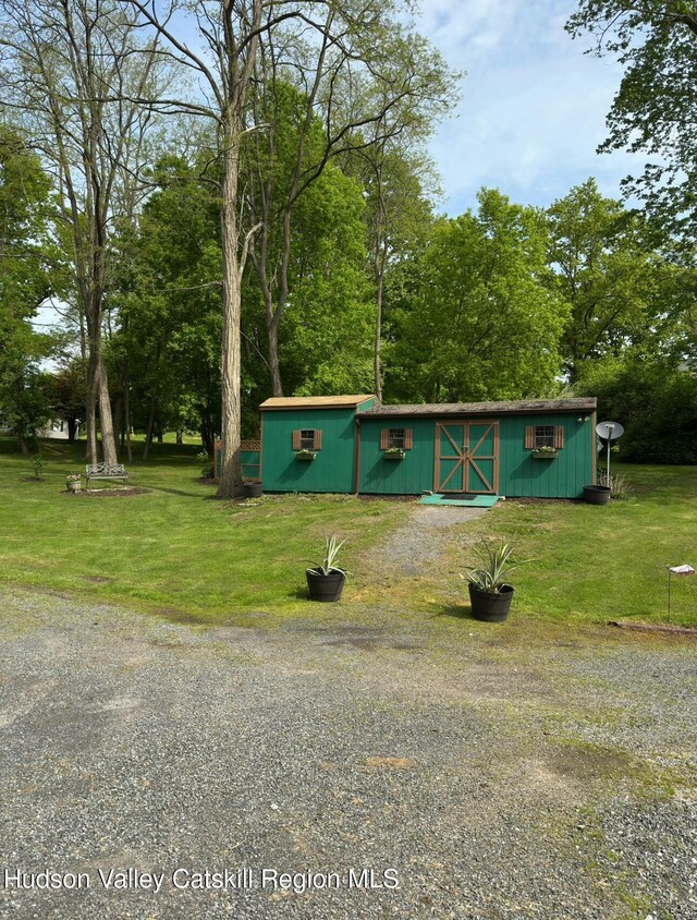 51 Patroon St, Claverack-Red Mills, NY 12513 - view of front facade with a front yard and view of wooded area